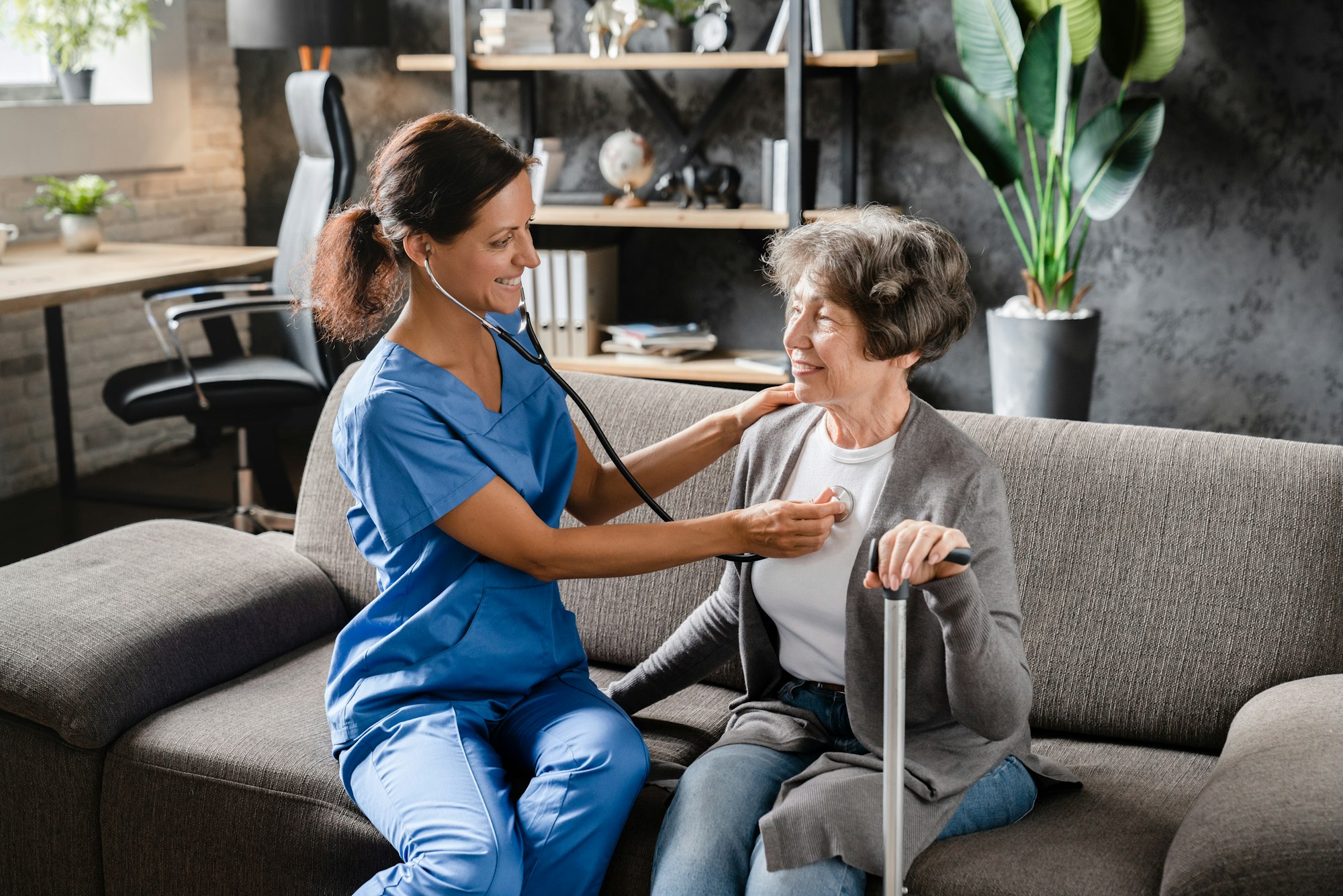 Nurse doctor caregiver listening to the patient`s chest heart lungs with stethoscope. Cardiovascular