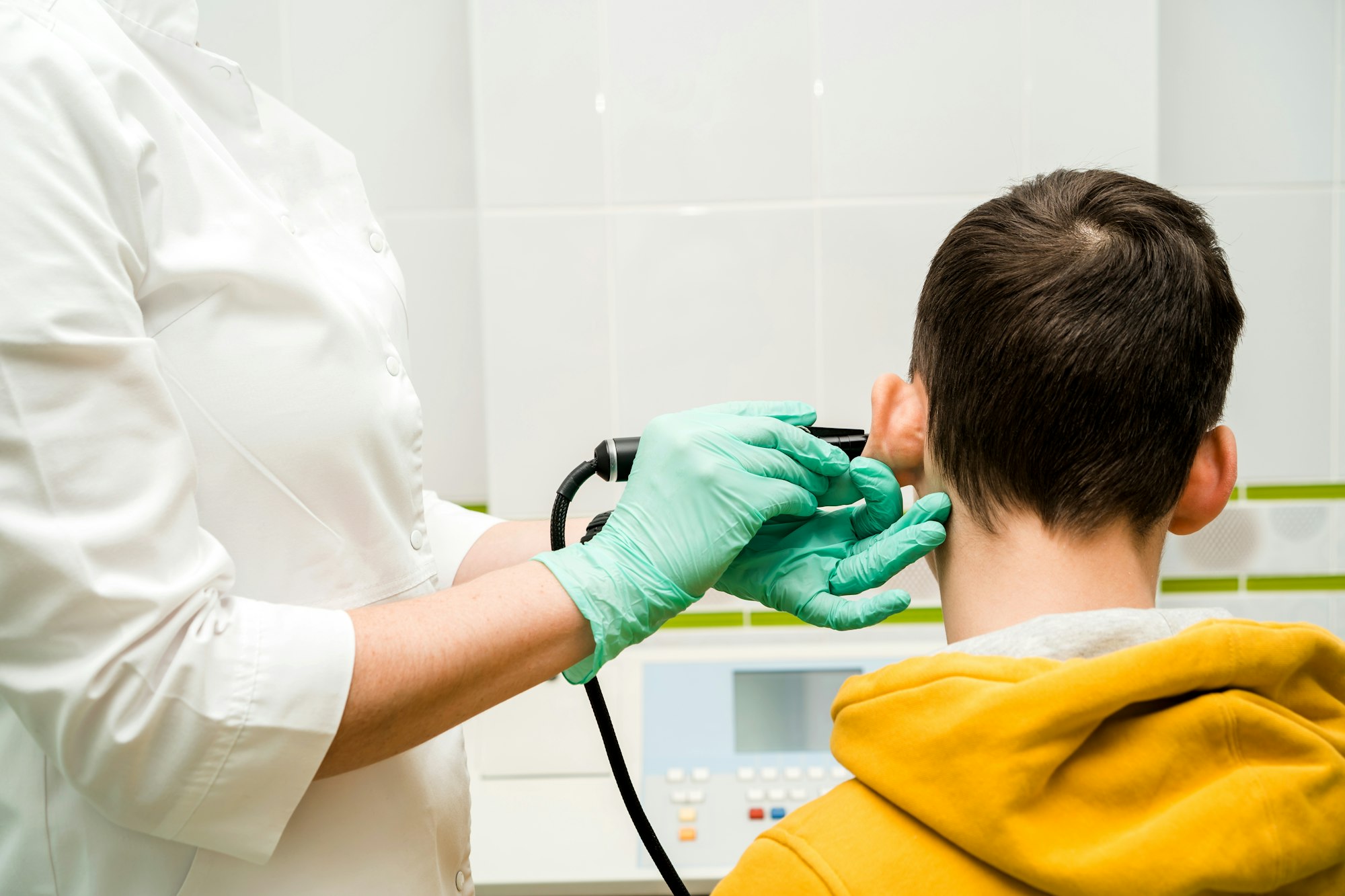 Preventive inspection of a teenage boy in a medical facility. Otorhinolaryngologist doctor