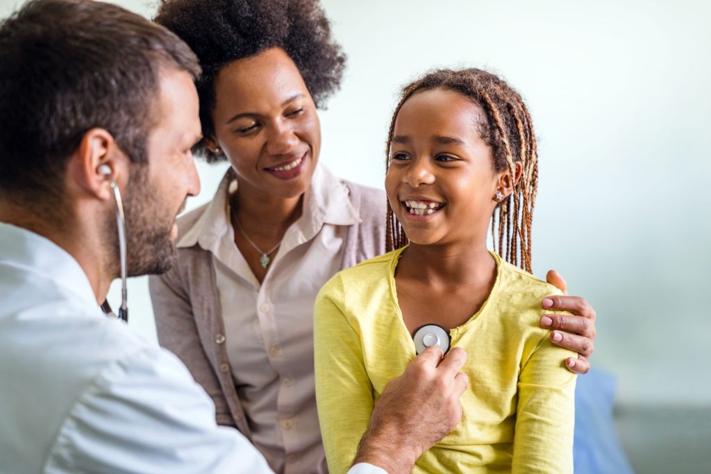 Doctor doing medical exam to a kid.