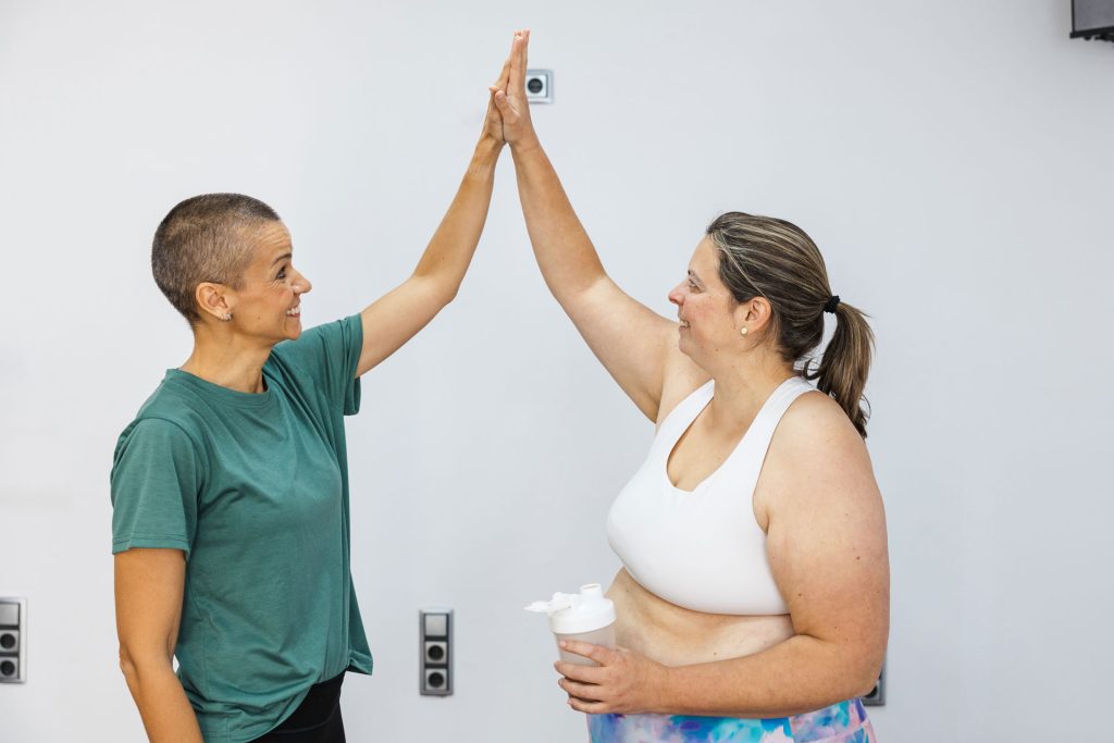 Personal trainer giving high five.