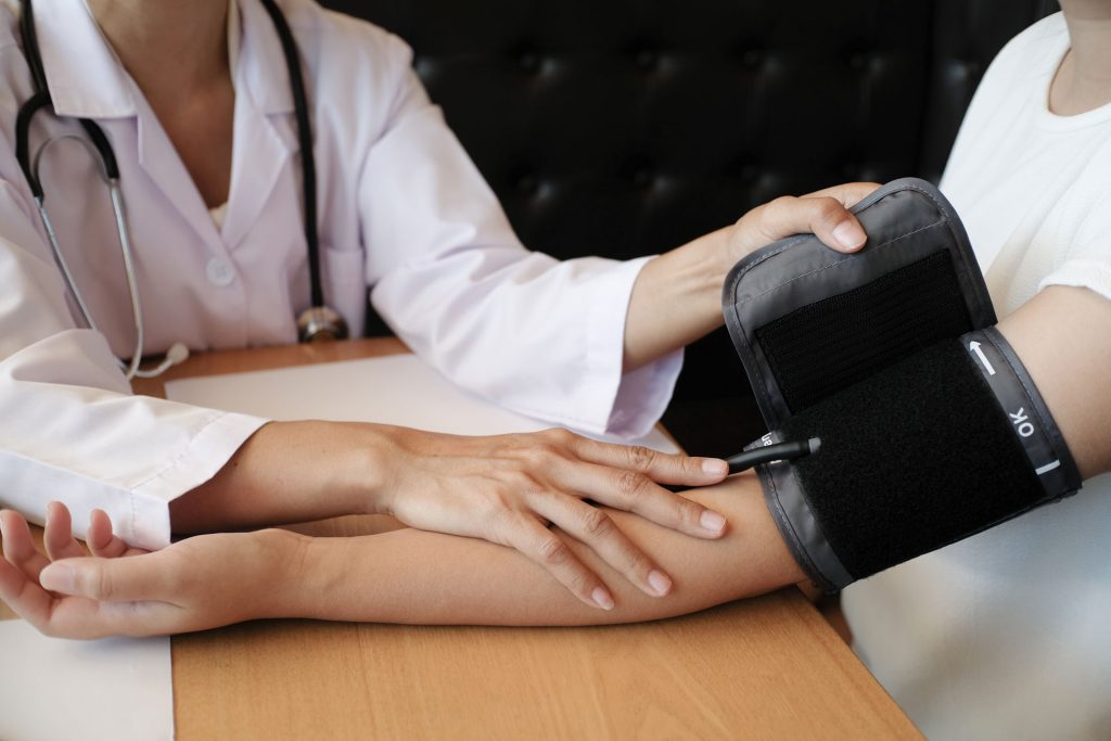 Doctor checking a patient's blood pressure.