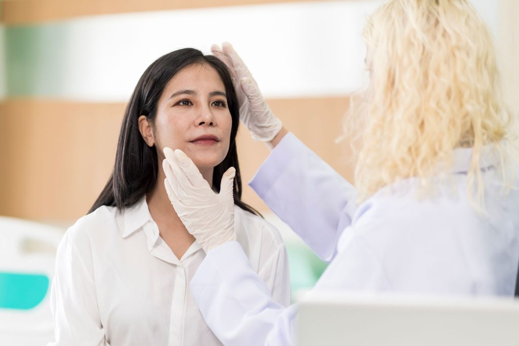 Woman getting a checkup from a female doctor.