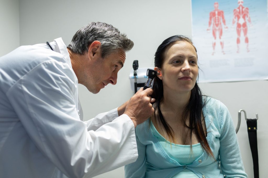 Doctor doing checkup to a patient.