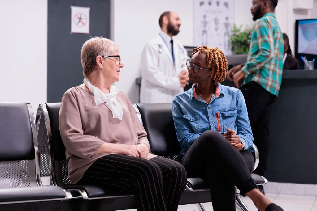 Diverse people sitting in hospital reception.