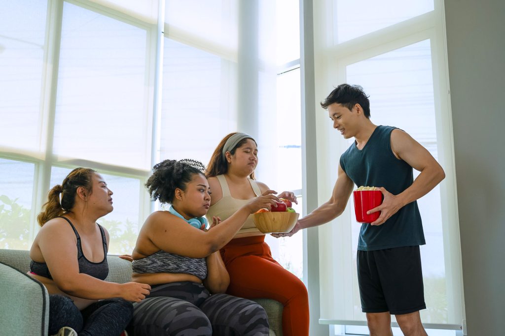 Plus-size women with their trainer for weight management.