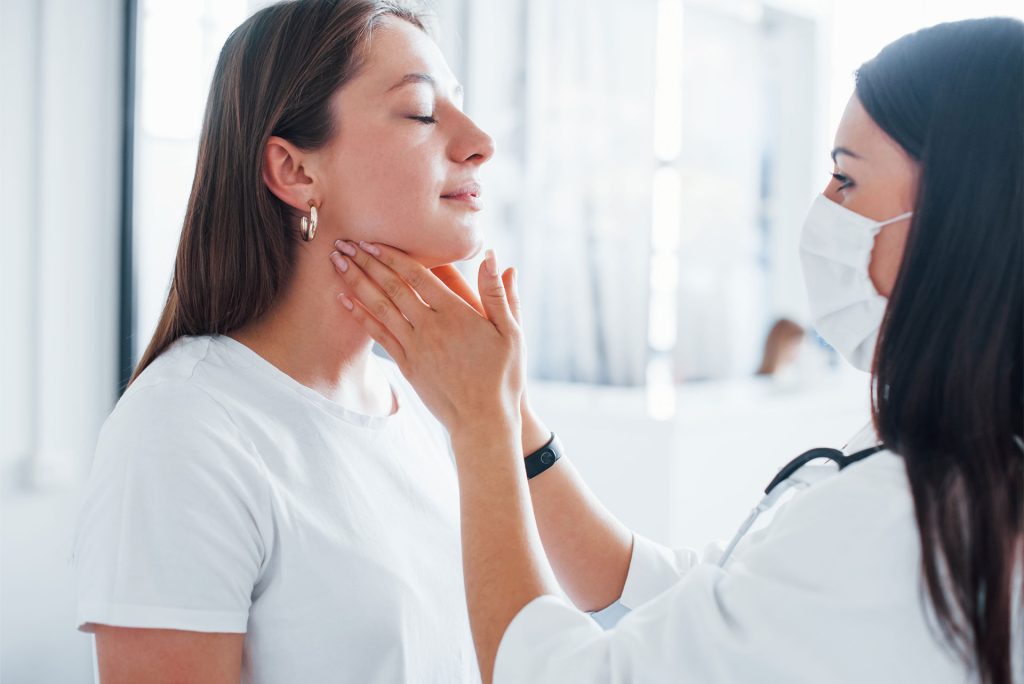 Checking thyroid of a woman for thyroid care.