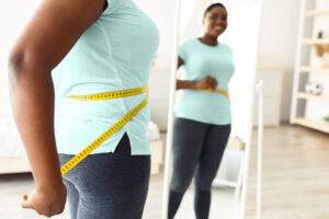 Woman measuring her waist.