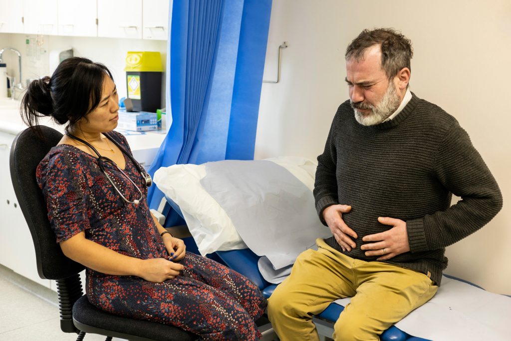Man consulting to a doctor about multiple chronic condition.