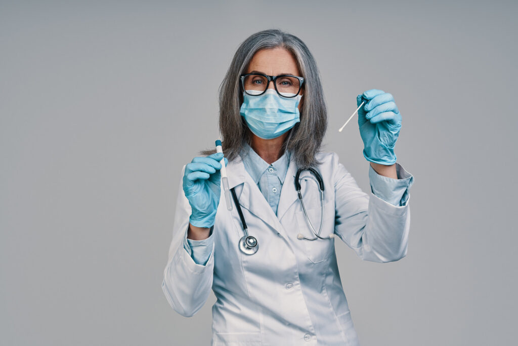 Female doctor holding swab test.