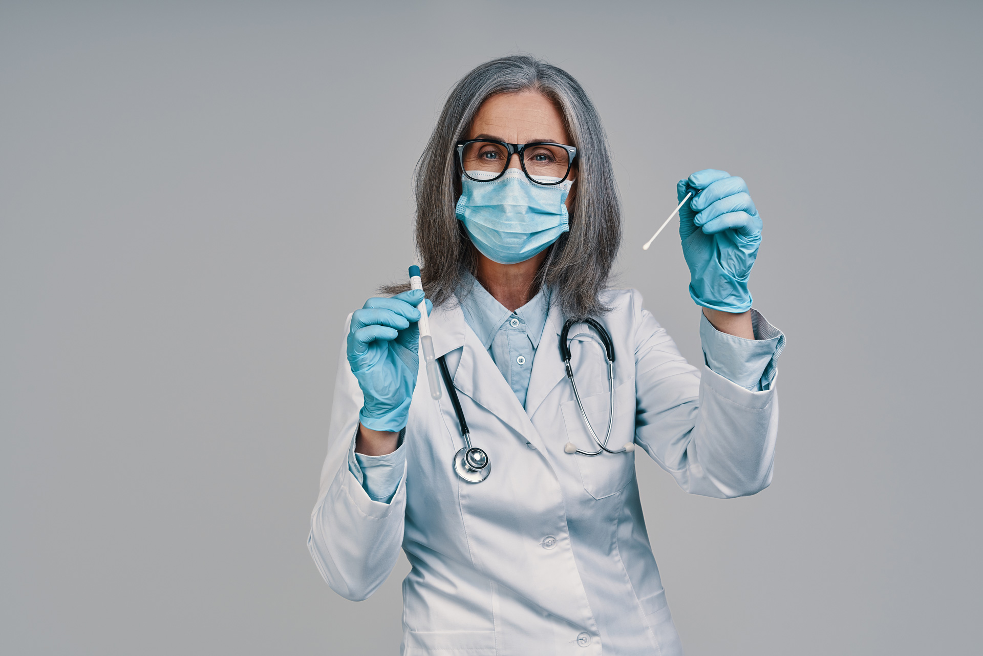 Female doctor holding swab test.