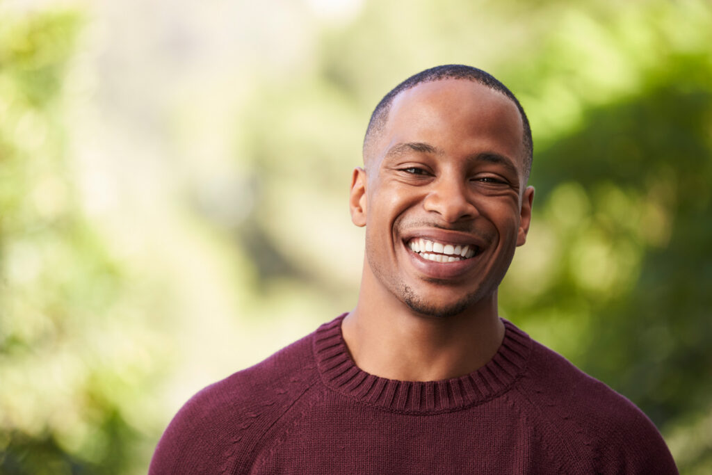 Happy man smiling outdoor.